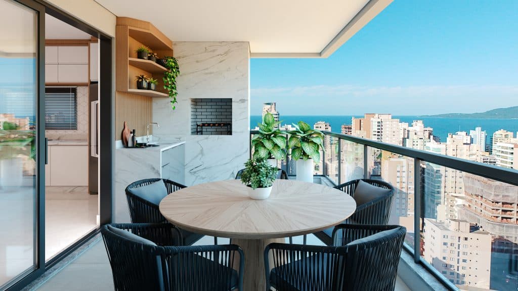 Imagem de uma varanda com vista para o mar. No espaço, é possível ver uma churrasqueira e uma mesa com quatro cadeiras.